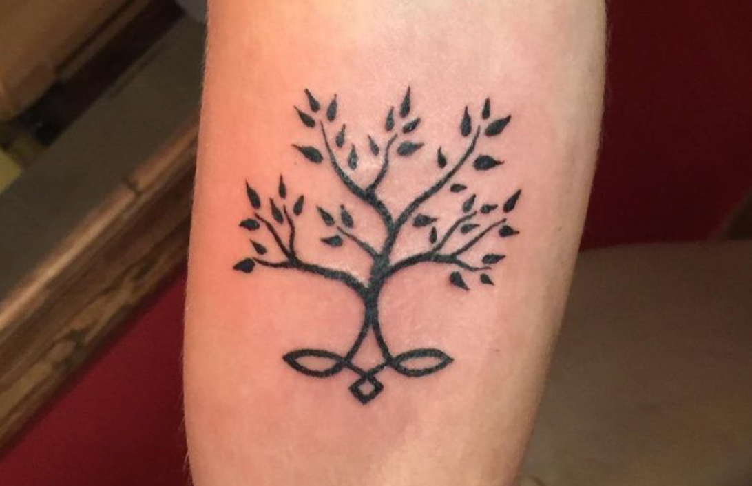 Small tree tattoos often symbolize the roots or origins